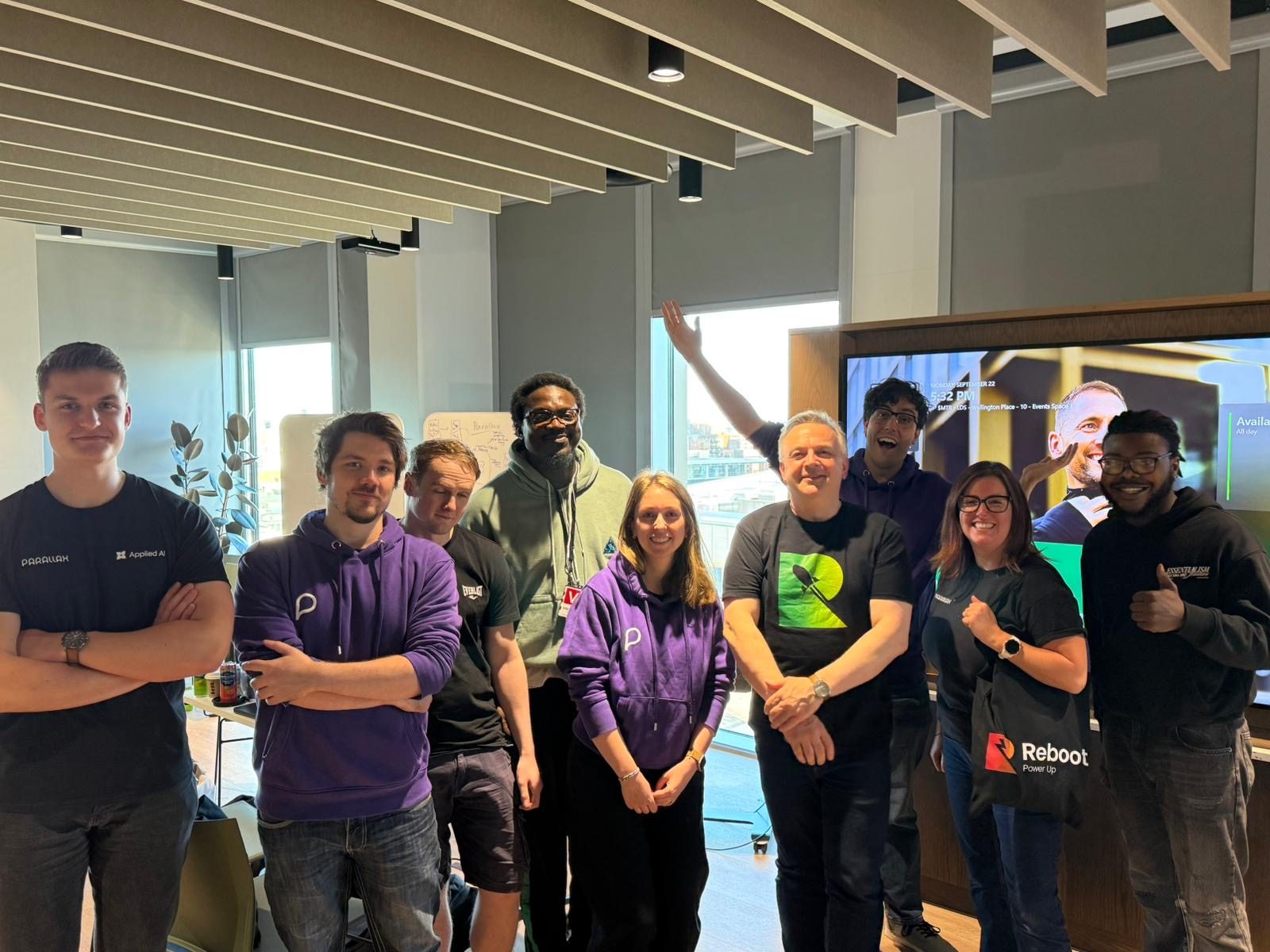 Group photo of hackathon participants and organisers, with Ikechukwu in a green hoodie at the centre back and a Reboot Power Up bag in front